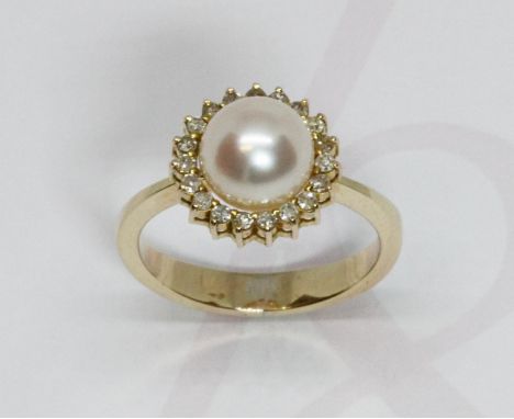 A cultured pearl and diamond cluster ring, the full pearl measuring approximately 8mm in diameter, surrounded by 19 diamonds,