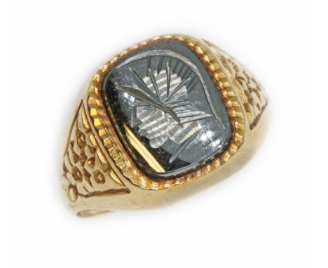 A hallmarked 9ct gold hematite intaglio ring, gross weight 5.1g, size R.  Condition - band slightly out of shape, otherwise o