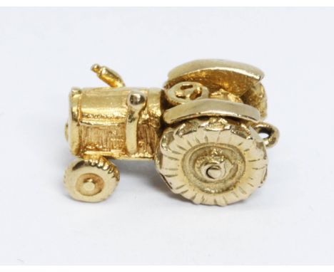 A hallmarked 9ct gold charm modelled as a tractor, length 15mm, weight 3.5g.  