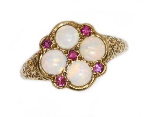 An opal and ruby cluster ring, the cluster measuring approximately 13.40 x 13.10mm, scroll shoulders, hallmarked 9ct gold, sp