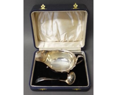 A cased hallmarked silver sauce boat and non matching hallmarked silver ladle, gross weight 4.2ozt.  