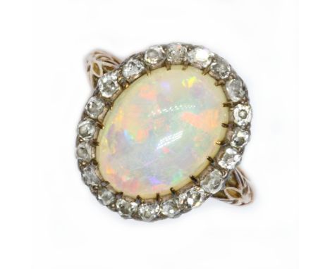 An antique opal and diamond ring, circa 1900, the opal cabochon measuring approximately 14.20 mm x 10.40mm, depth 4.84mm, sur
