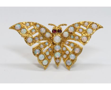 A novelty butterfly brooch, set with opal cabochons all over and rubies for eyes, hallmarked 9ct gold, sponsor 'H.B.', London