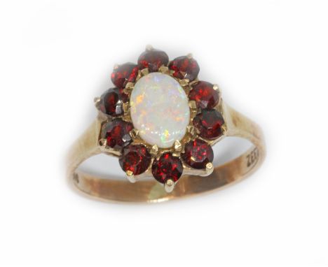 An opal and garnet cluster ring, marked 'ZEETA' and '9ct', gross weight 2.8g, size M.  Condition - good, general wear.