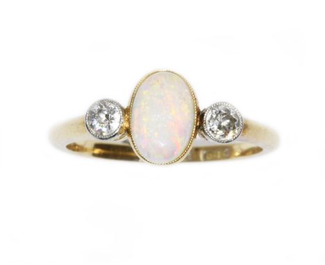 An antique opal and diamond ring, the oval opal cabochon measuring approximately 8.05mm x 5.80mm, depth 2.40mm, set between t