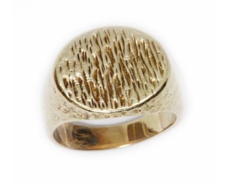 A yellow metal signet ring, textured and hammered finish, unmarked, weight 14.8g, size R.  Condition - tests as 9ct, general 