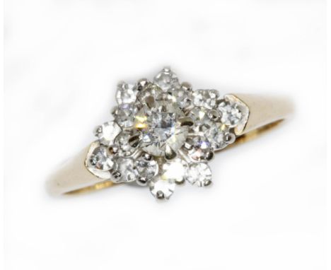 A diamond cluster ring, the principal diamond weighing approximately 0.25 carats, surrounded by 18 melee diamonds, band marke