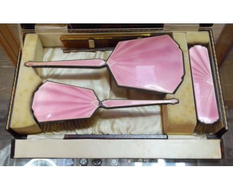 An early 20th century cased hallmarked silver and pink enamel dressing table set.  