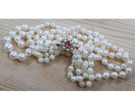 A double strand of graduated cultured pearls, hallmarked 9ct gold split pearl pink stone clasp, length 44cm, gross weight 38.