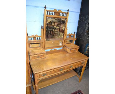 A Victorian ash and inlaid bedroom suite comprising a mirrored door wardrobe, a dressing table with adjustable mirrored back 