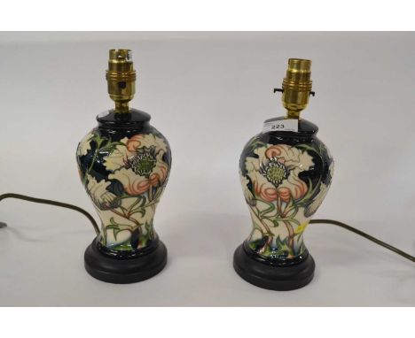 A pair of Moorcroft table lamps, the ceramic bodies with tubelined floral design, ceramic lamp 20cm high