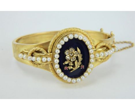 An antique 18ct gold bracelet with diamond and ruby inset floral cartouche on enamel. The cartouche surrounded by a seed pear