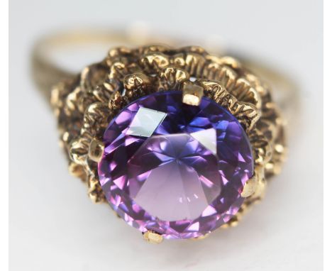 A 9ct gold ring set with a round brilliant cut amethyst, the stone approx. 4.44 carats, band marked '9ct', gross wt. 6.88g, s