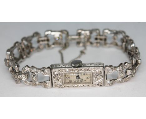 A 1920s Art Deco diamond encrusted platinum cocktail bracelet watch, seventeen jewel movement, inside case marked 'PLAT', gro
