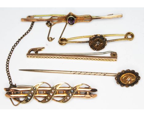 A group of gold brooches comprising two marked '9ct', one set with an amethyst marked '15ct' and another unmarked and set wit