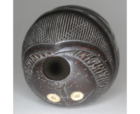 A carved coconut bugbear powder flask with bone eyes, length 10cm.  