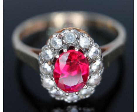 A hallmarked 9ct gold ruby and colourless stone cluster ring, gross wt. 2.31g, size M.  