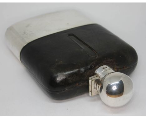 A silver plated and leather covered glass hip flask, length 16cm.  Condition - good, glass damage free, general wear througho