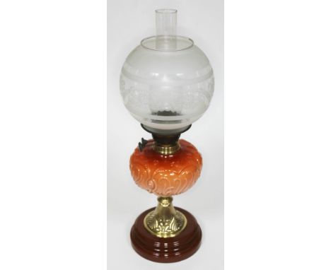 A Duplex oil lamp with pressed glass reservoir, embossed brass pedestal and stoneware foot, with etched glass shade and flu, 