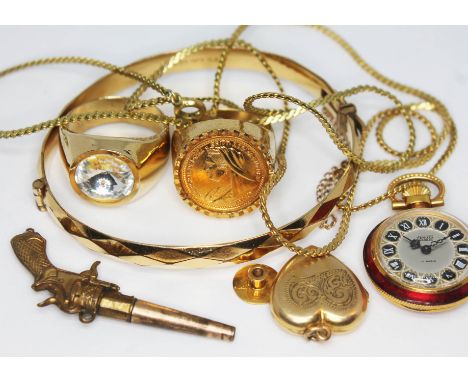 A mixed lot of yellow metal comprising a bangle, two signet rings, a pistol charm, locket etc.  