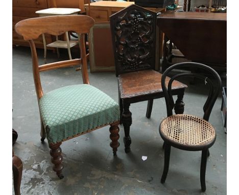 A walnut occasional chair on bobbin turned legs; together with a heavily carved hall chair; and a small caned thonet style ch