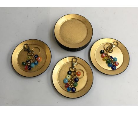 Ten lacquered saucers; together with three glass keychains 