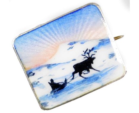 A silver and enamel rectangular brooch, the enamel depicting a winter scene with sunrise and figure of sleigh being pulled by