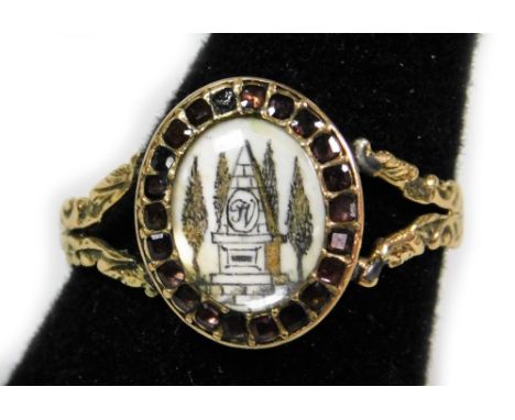 A Victorian style memorial ring, with oval memorial panel depicting column and trees, bearing inscription J V, surrounded by 