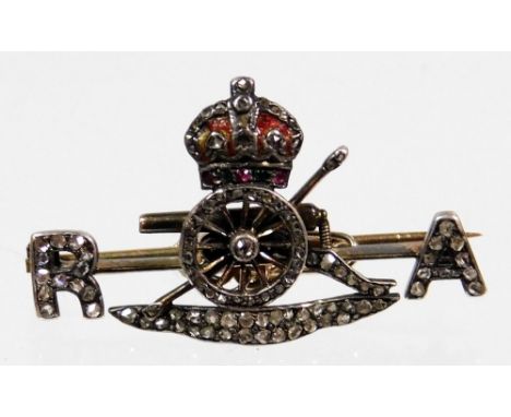 A Royal Artillery brooch, set with old cut diamonds, enamel, garnet and emerald set design, bearing RA emblem and canon wheel