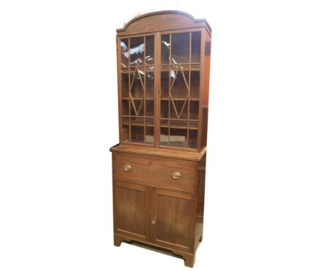 A Regency mahogany cabinet secretaire bookcase, with reeded arch top, over two lozenge astragal glazed doors, the secretaire 