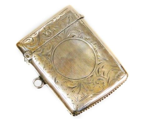 A George V silver vesta case, with engine turned decoration with scrolls and flowers, with vacant cartouche crest, match stri
