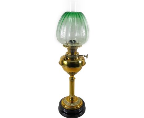 An early 20thC oil lamp, with green, clear and etched glass neo-classical shade, clear funnel and shaped brass reservoir and 