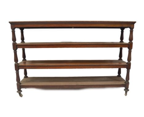 A Victorian mahogany serving buffet,  with four rounded rectangular platforms joined by tulip carved uprights, on brass and c