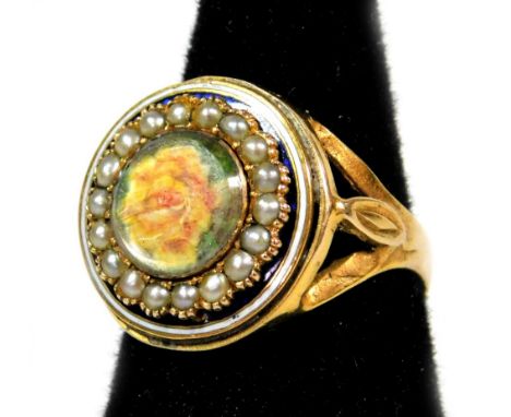 A Victorian memorial ring, with painted rose centre surrounded by seed pearls, with blue and white enamel border, on a yellow