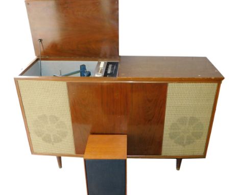 A 1970's radio gram, with Monarch turntable, Bush tuner, in a teak case with front speakers, 79cm H, 125cm W 41cm D and a fur