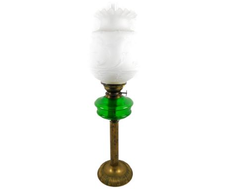 An early 20thC oil lamp, with clear glass funnel, frosted moulded glass shade with flared rim and a green glass reservoir, on