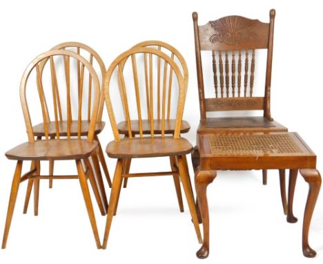 A set of four vintage Ercol light elm hoop back dining chairs, with stick backs, shaped seats and turned legs joined by H str