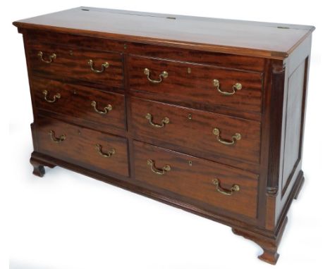 An early 19thC Lancashire oak and mahogany mule chest, the hinged lid raised above two dummy and four real drawers, each with