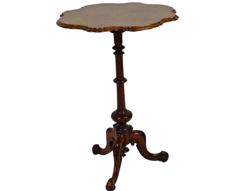 A late Victorian walnut occasional table, the flowerhead top with a inlaid floral centre, on a turned stem and tripod base, 7