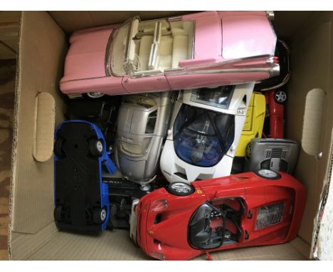 A box of 1:18 scale diecast vehicles, all unboxed