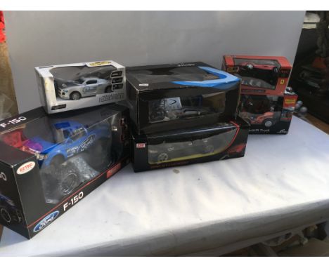 A box of remote controlled vehicles including a ford monster truck, a hovercraft, a Dong Xin car, fork lift truck etc, all Bo