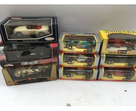 A collection of boxed 1:24 scale F1 cars and 3 Diecast 1:18 scale vehicles including Porsche, Caterham super 7 and an MGB Mk1