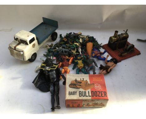 A box containing a collection of plastic figures, Herman figures, a static steam engine, a Triang tinplate truck and a boxed 