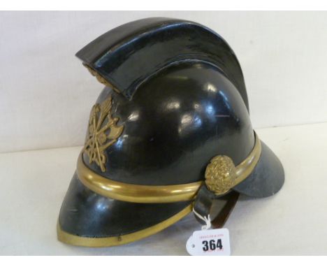 19thC leather fireman's helmet with brass dragon mask to face of raised comb, axe and flaming torch badge to front, possibly 