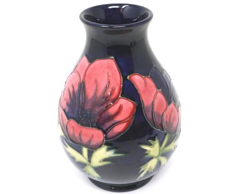 Blue ground Moorcroft vase in the Anemone pattern, H: 20 cm, light crazing throughout, no cracks or chips. P&amp;P Group 2 (£