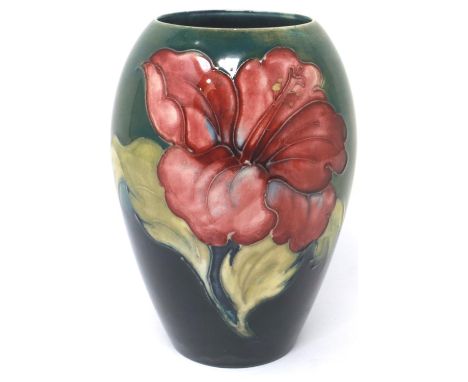 Green ground Moorcroft vase in the Hibiscus pattern, with the Late Queen Mary sticker to base, H: 14 cm, small chip to base. 