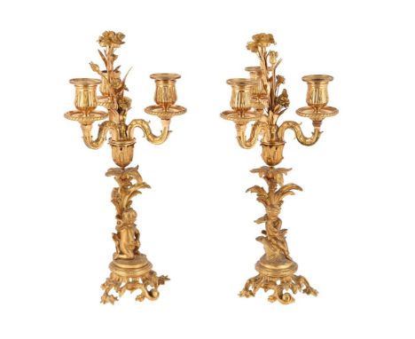 A PAIR OF FRENCH ORMOLU AND GILT METAL CANDLESTICKS  LATE 19TH CENTURY With floral sconce supported on a stiff leaf and with 