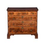 A WALNUT AND FEATHERBANDED CHEST OF DRAWERS