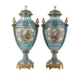 A PAIR OF FRENCH PORCELAIN AND GILT METAL MOUNTED SEVRES STYLE 'JEWELLED' TURQUOISE GROUND URNS AND