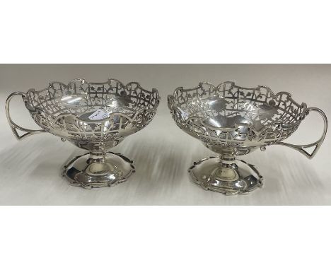 A pair of pierced silver cups with floral decoration. Sheffield. By EV. Approx. 204 grams. Est. £100 - £150.